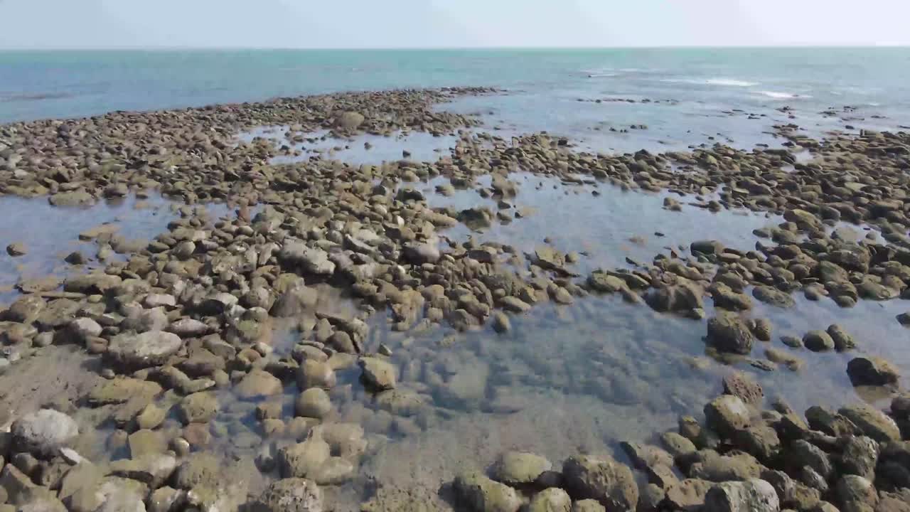 Aerial View of Rocky Shore with Clear Water