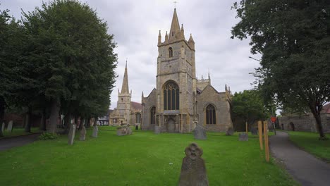 the medieval gothic tower of st lawrence's church and graveyard in evesham, worcestershire, england, uk