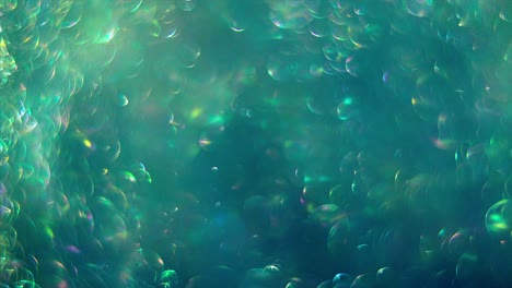 abstract green-blue background with chaotical motion of transparent soap bubbles. balls rotation, abstract molecular brownian motion.