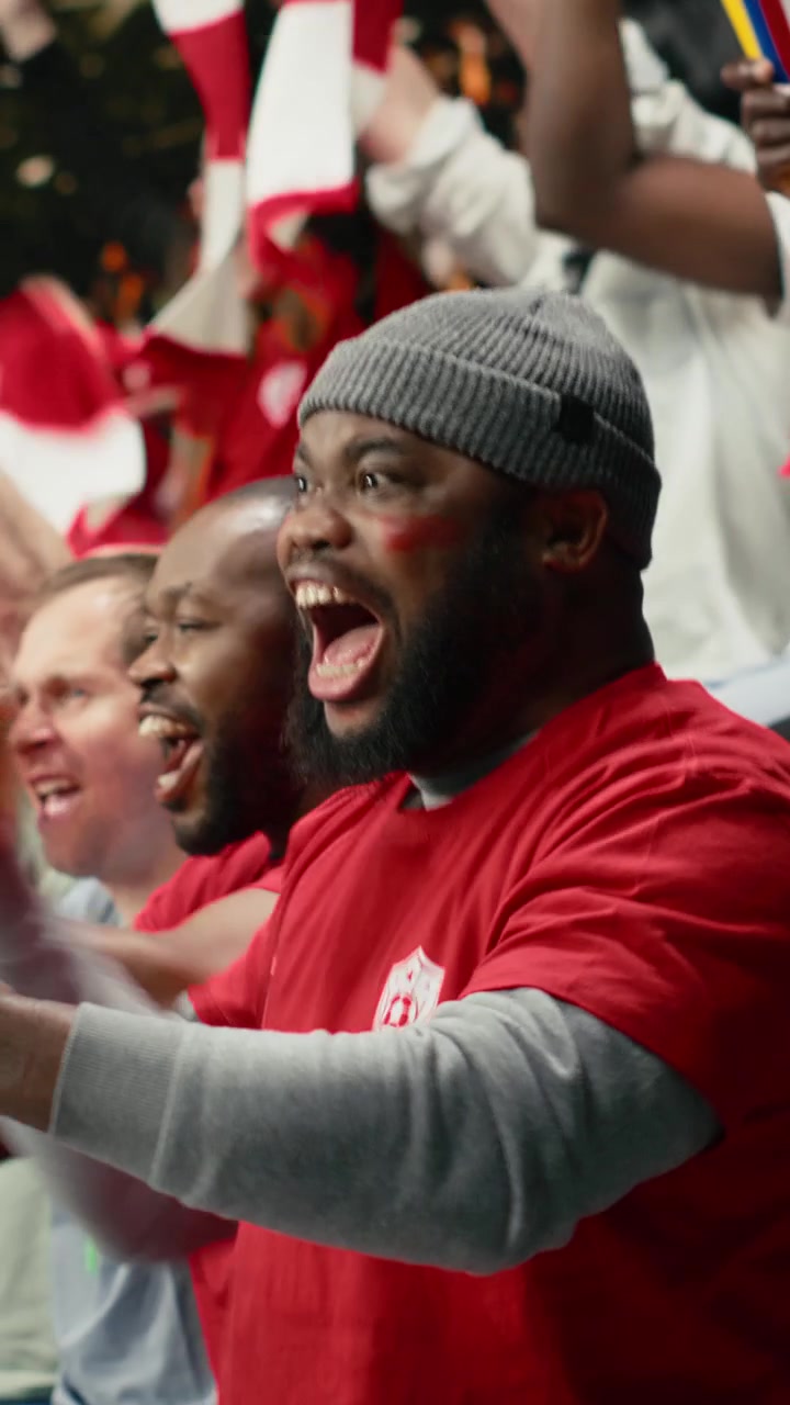 Vertical Video Shocked black fan celebrating betting lucky win with adrenaline