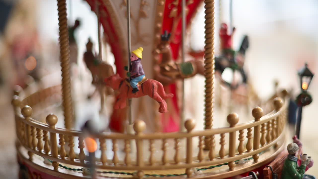 Close up of a miniature vintage carousel with decorative horses and ornate details