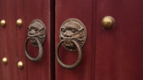 decorative door knobs on ancient wooden door at temple in the mountainous region of ninh ninh in northern vietnam