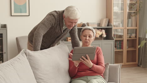 senior couple using tablet