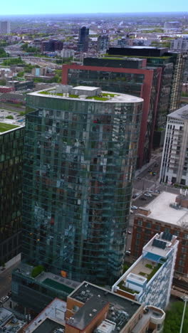 modern mirror buildings with green grass lawn on the roofs. panorama of stunning vibrant chicago at daytime. top view. vertical video