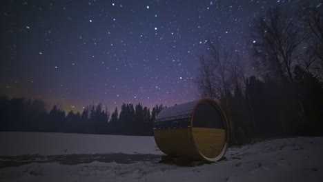 beautiful stars at night over forest and thermowood barrel sauna