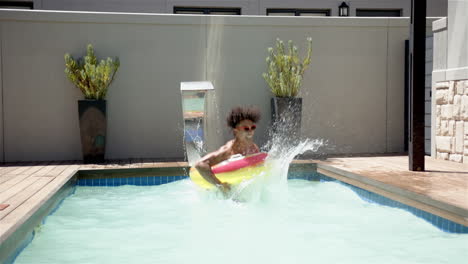 swimming in pool, man splashing water while floating on inflatable raft, copy space
