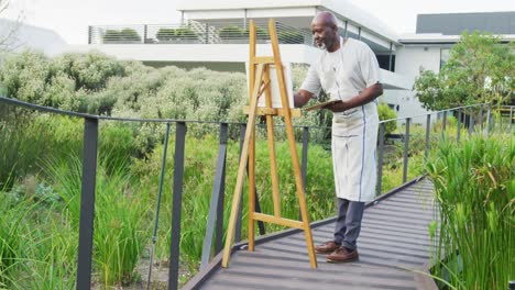 video of happy senior african american men painting