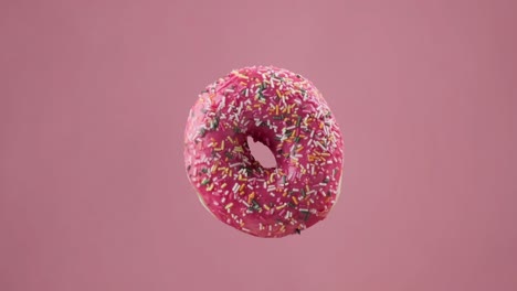 various colorful donuts. different delicious donuts changing at pink background.