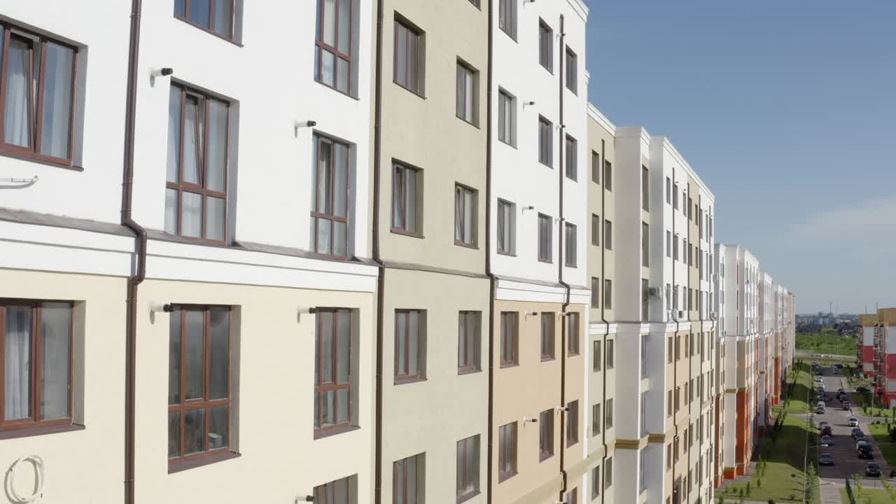 Tilt up drone view of facade of modern typical new residential building with light walls in contemporary city district