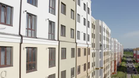 tilt up drone view of facade of modern typical new residential building with light walls in contemporary city district