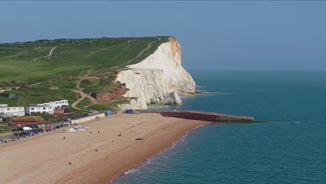 Revealing the front sea of Seaford, England, with the iconic white cliffs rising in the background along the stunning coastline