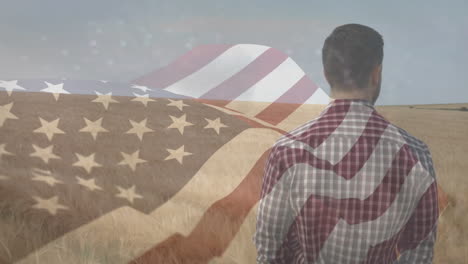 animación de la bandera de américa ondeando sobre un agricultor de pie en un campo de trigo