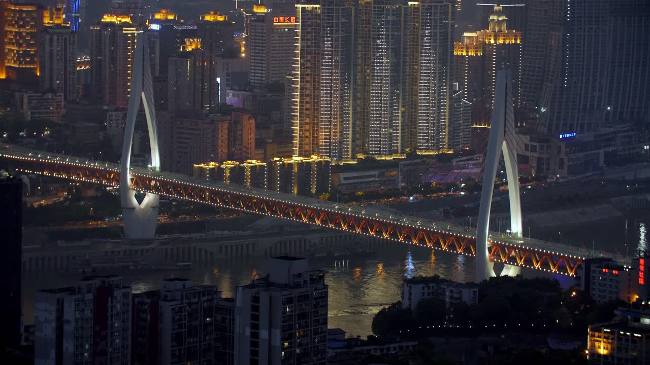 Dongshuimen Bridge over the Yangtze River illuminated at night with heavy traffic of vehicles, Locked establishing shot