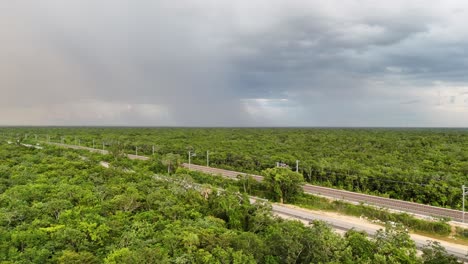Cloudy sky pouring rain over the dense jungle. Yucatan, Mexico