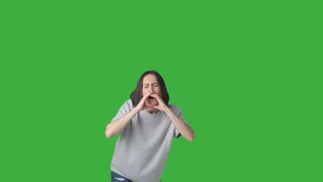 woman shouting and listening over green background