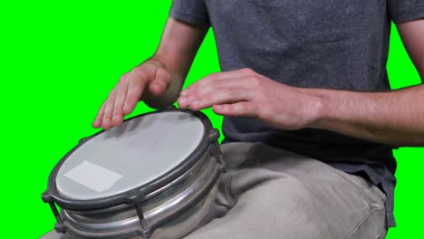 Mid-section-of-drummer-playing-drum