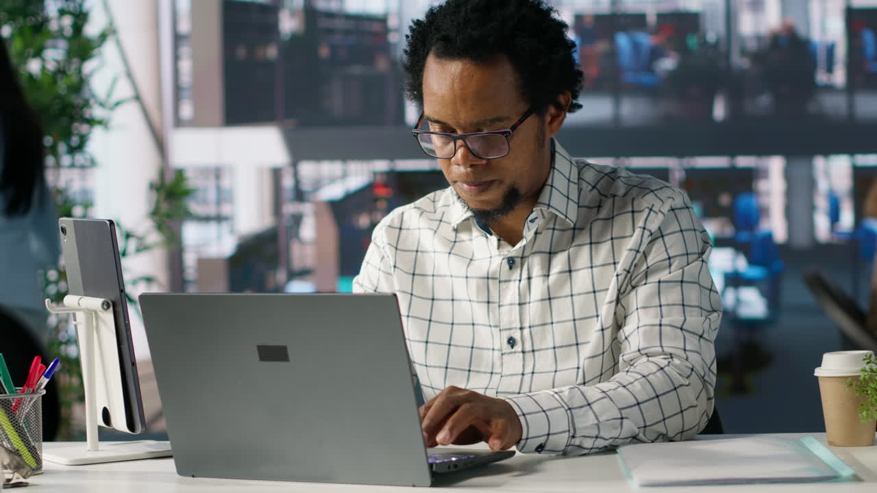 Man working on laptop in modern office