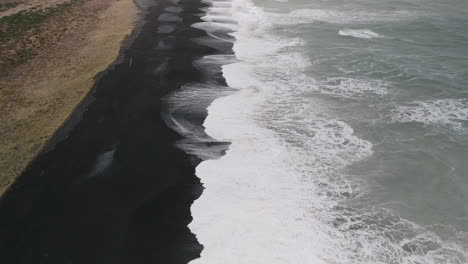black sand beach with powerful waves
