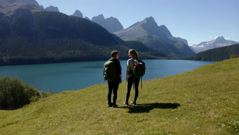 hikers enjoying the view of a mountain lake