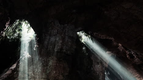 sunbeams shining through cave entrance