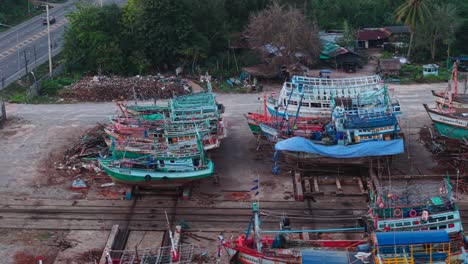fishing boats under repair in a shipyard