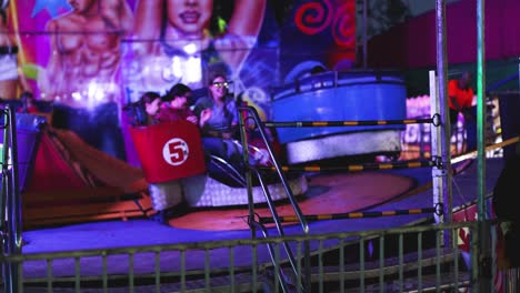 people enjoying a spinning amusement park ride