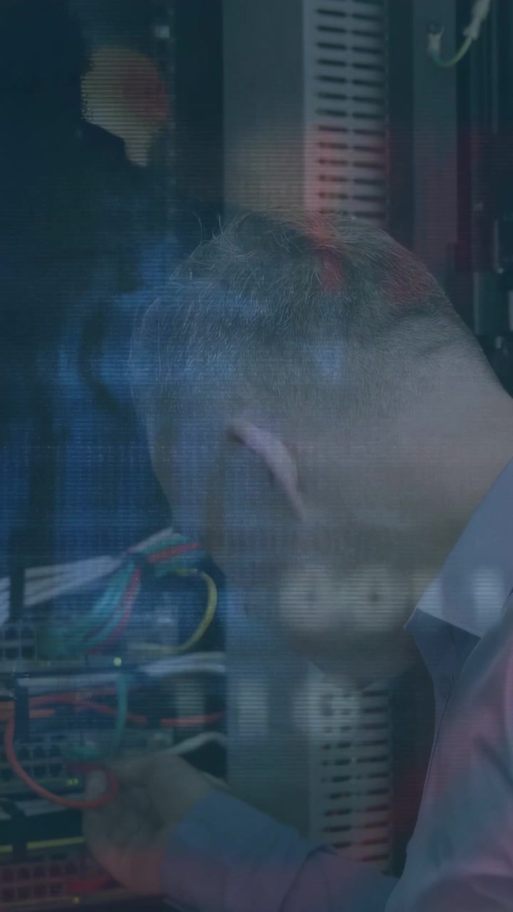Vertical video: Tech seeing alert, adjusting rack cables to fix network while overlays appearing