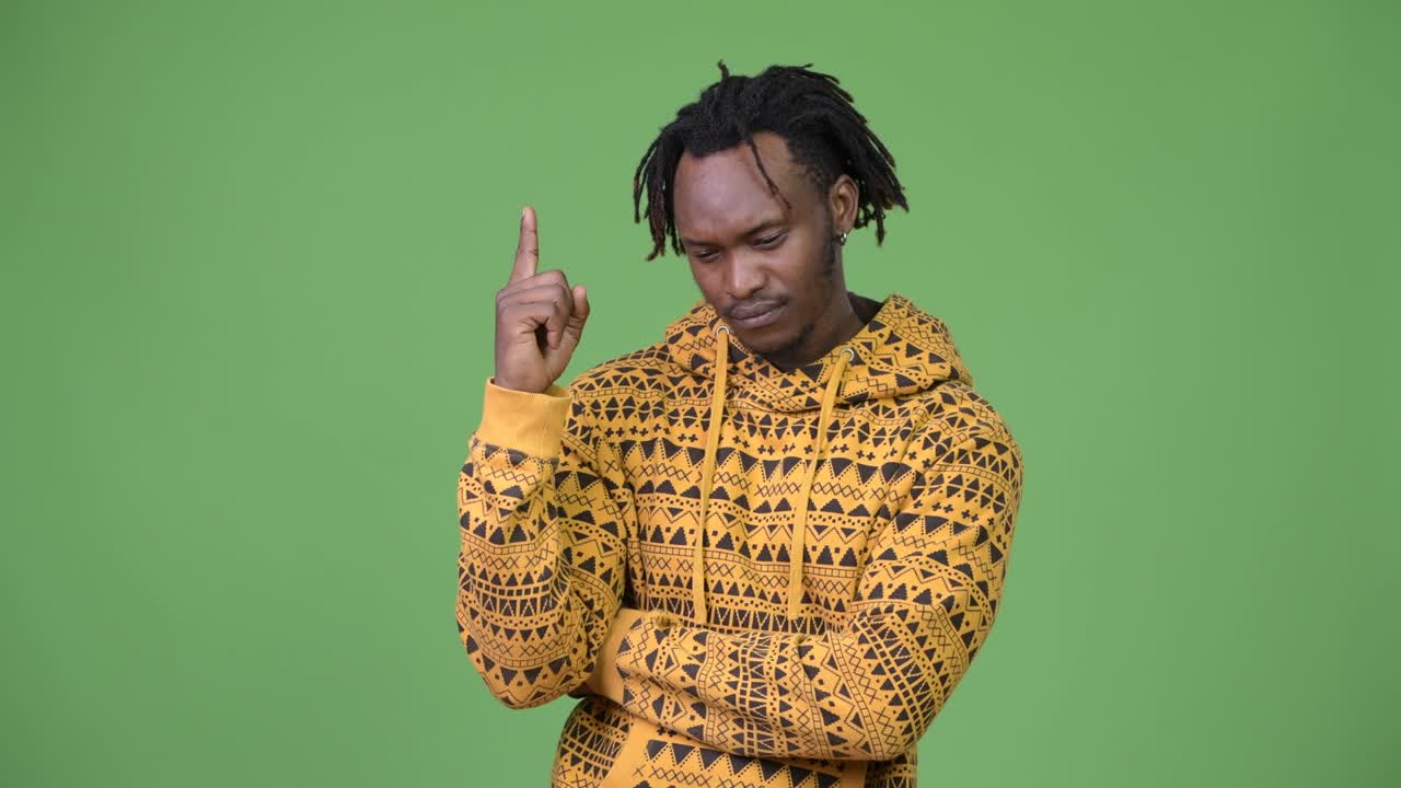 Young handsome African man thinking while pointing up