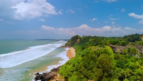 aerial drone footage flying over sk town surfer beach in weligama, sri lanka.