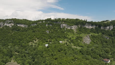 steep hillside with cliff and katskhi monastery on tall rock pillar