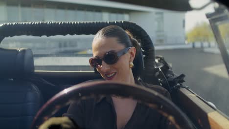 woman driving a vintage convertible