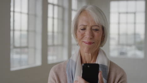 portrait of middle aged woman using smartphone texting browsing online social media sending sms messsaging enjoying mobile technology