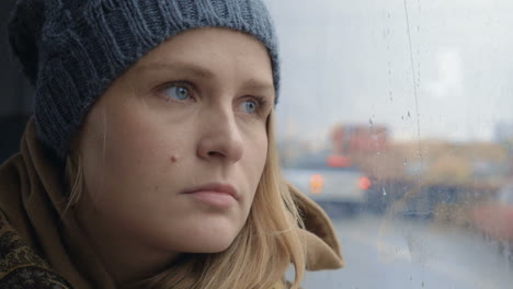 frustrated and sad woman traveling by bus on rainy day