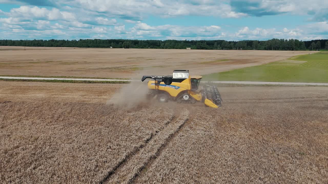 25 august 2024 Penkule, Latvia - Aerial View of Combine Harvester at Work. Summer Field Work on the Farm. Top View of Combine Gathering Corn or Wheat Crop.