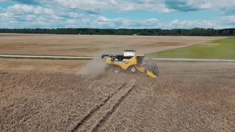 25 august 2024 penkule, latvia - aerial view of combine harvester at work. summer field work on the farm. top view of combine gathering corn or wheat crop.