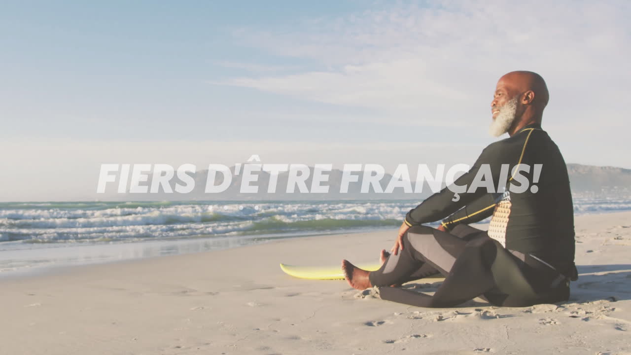 sentado en la playa con una tabla de surf, hombre con barba sobre orgulloso de ser animación francesa