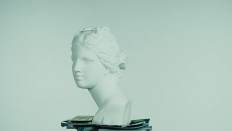 ancient bust on a pile of money