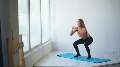 woman doing squats in a fitness studio