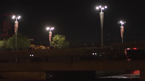 night view of a city bridge with people