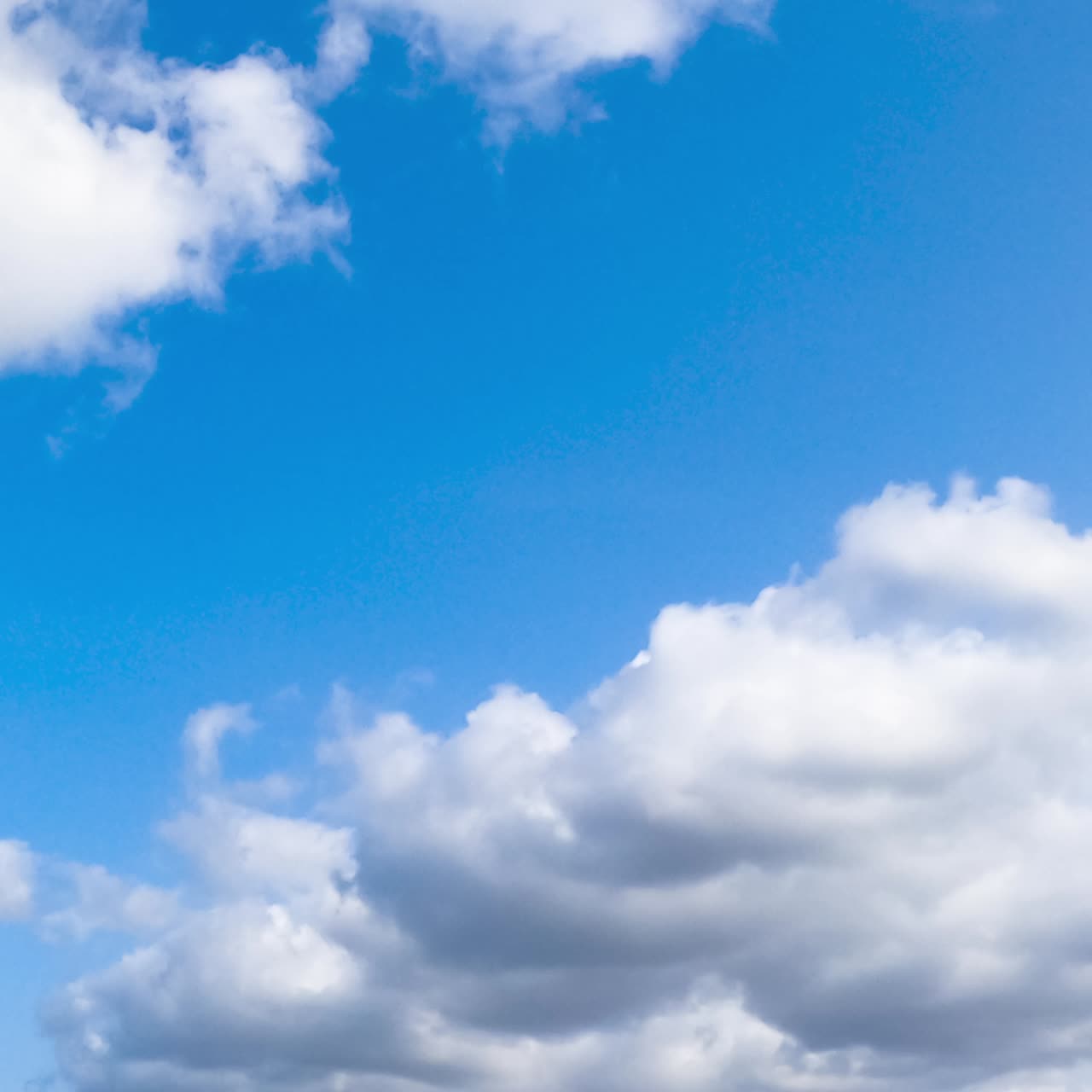 Light clouds on blue bright sky. Summer sky motion of cloudscapes