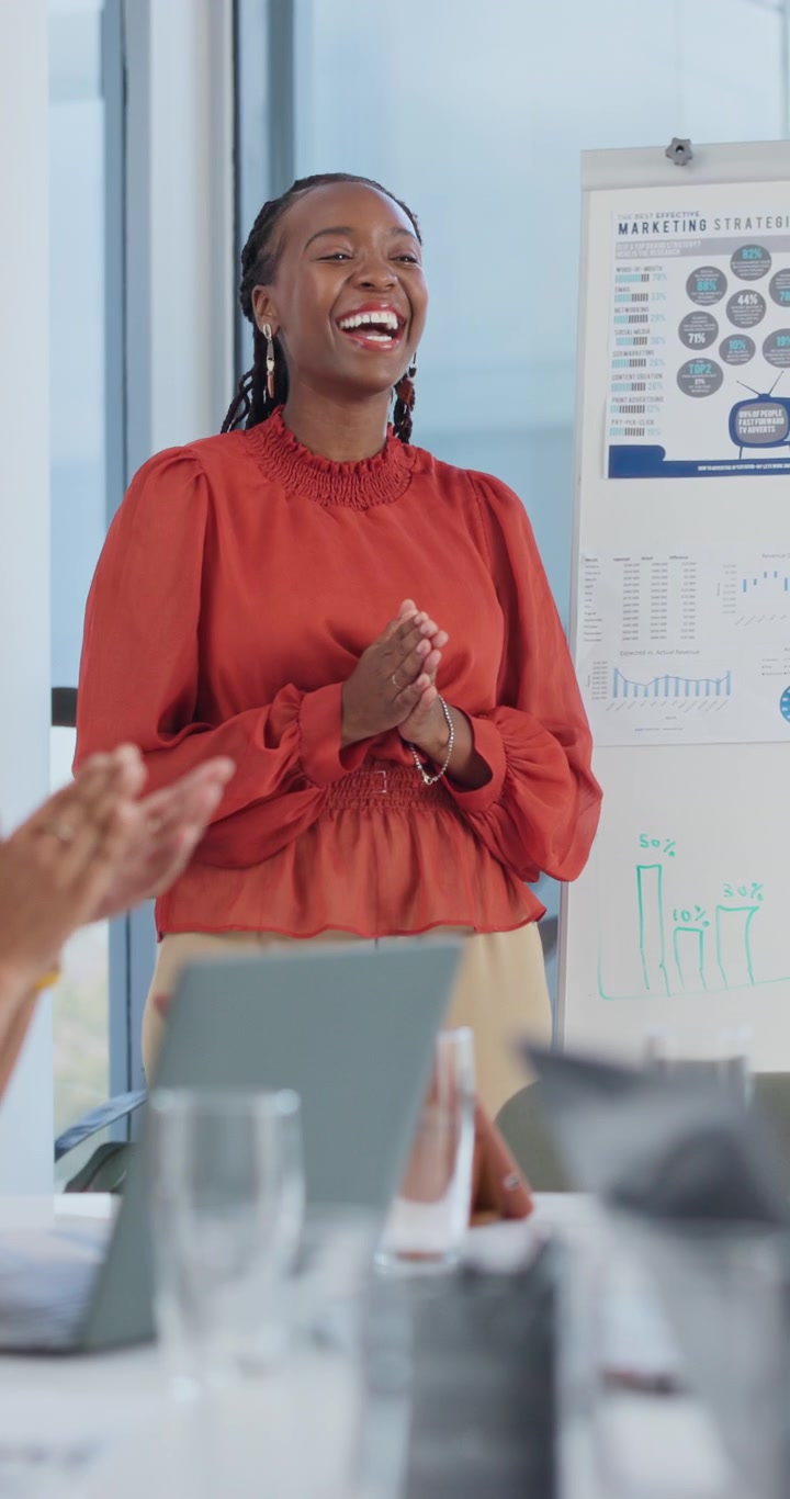 Businesswoman Presenting Marketing Strategy to Team in Office