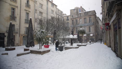 snow falling in montpellier ecusson square with restaurants and bars. france