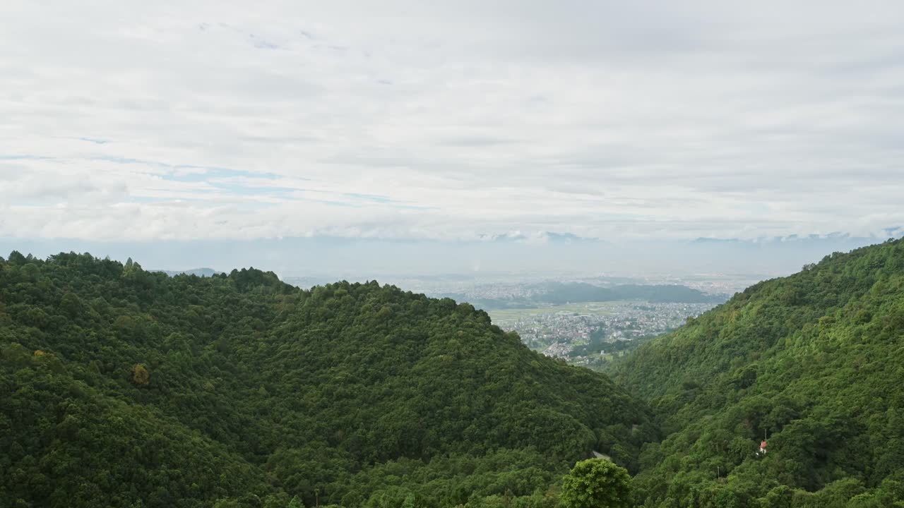Kathmandu Valley and Himalayas Mountains Scenery, Forest Landscape in the Foothills and Kathmandu Cityscape with the City Behind