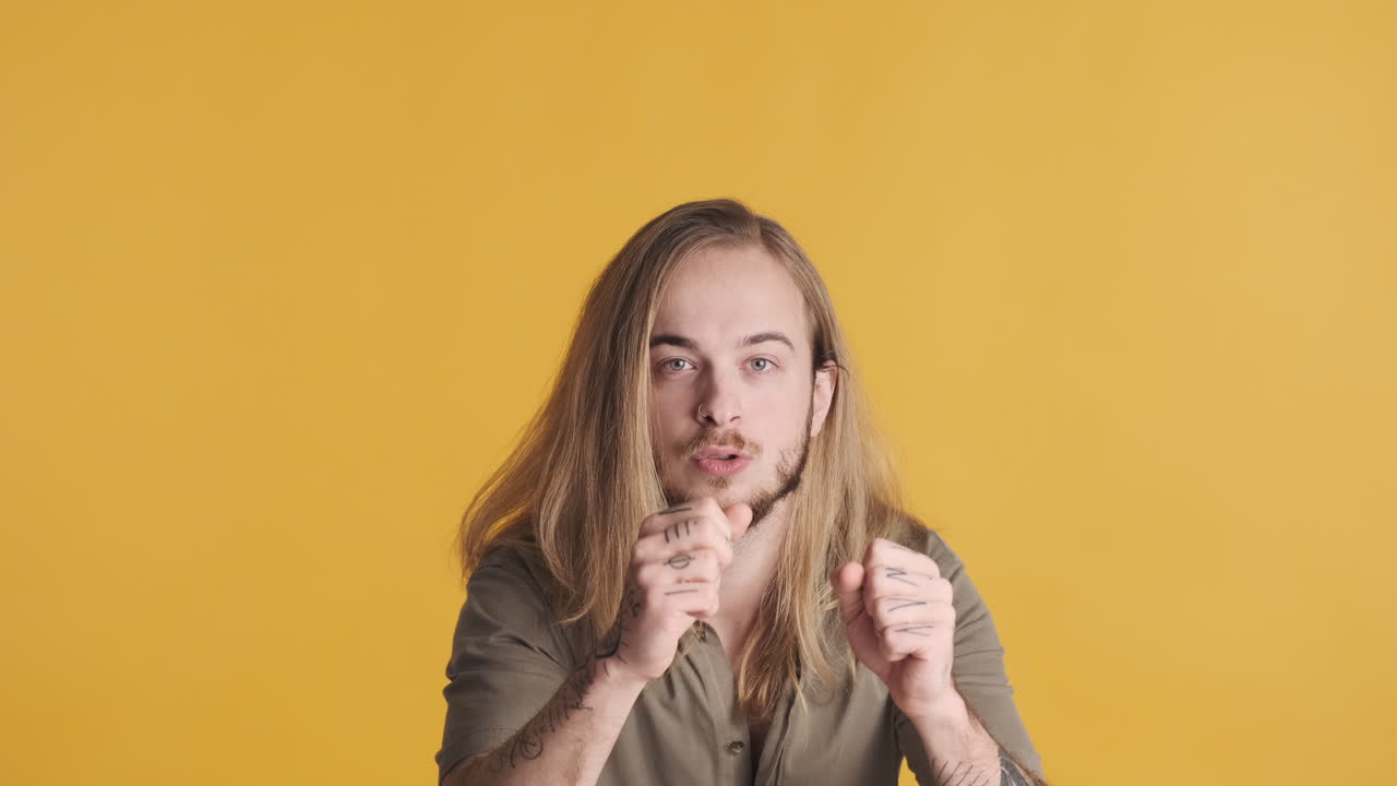 Caucasian young man celebrating in front of the camera.
