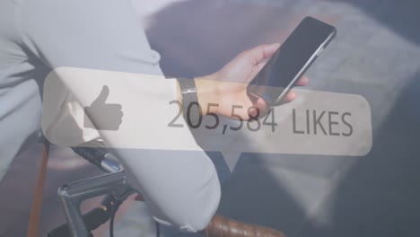thumbs up icon and increasing likes against mid section of woman with bicycle using smartphone