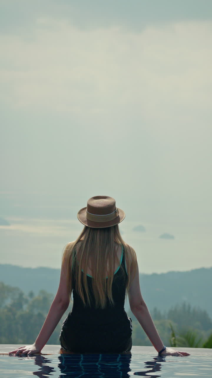 Woman Relaxing by the Pool with Ocean View