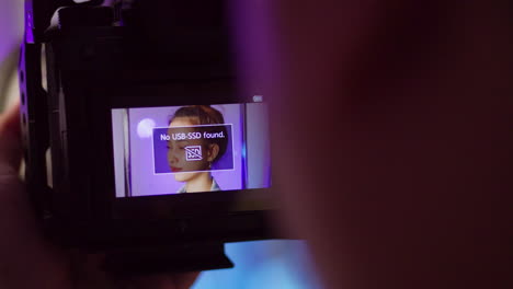 photoshoot for a fashion photography using a digital camera to take a shot of a female model.