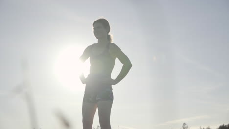 slomo of young woman resting after a run at sunset