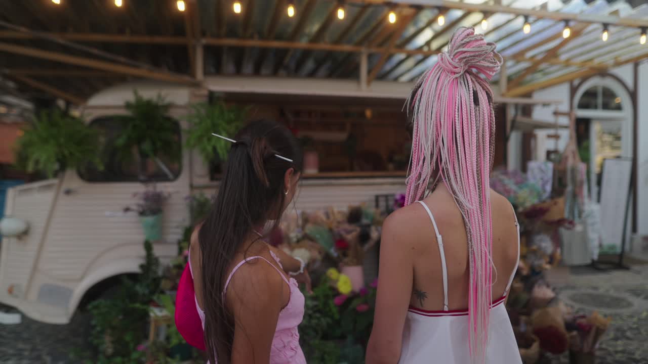 Two women at a flower truck