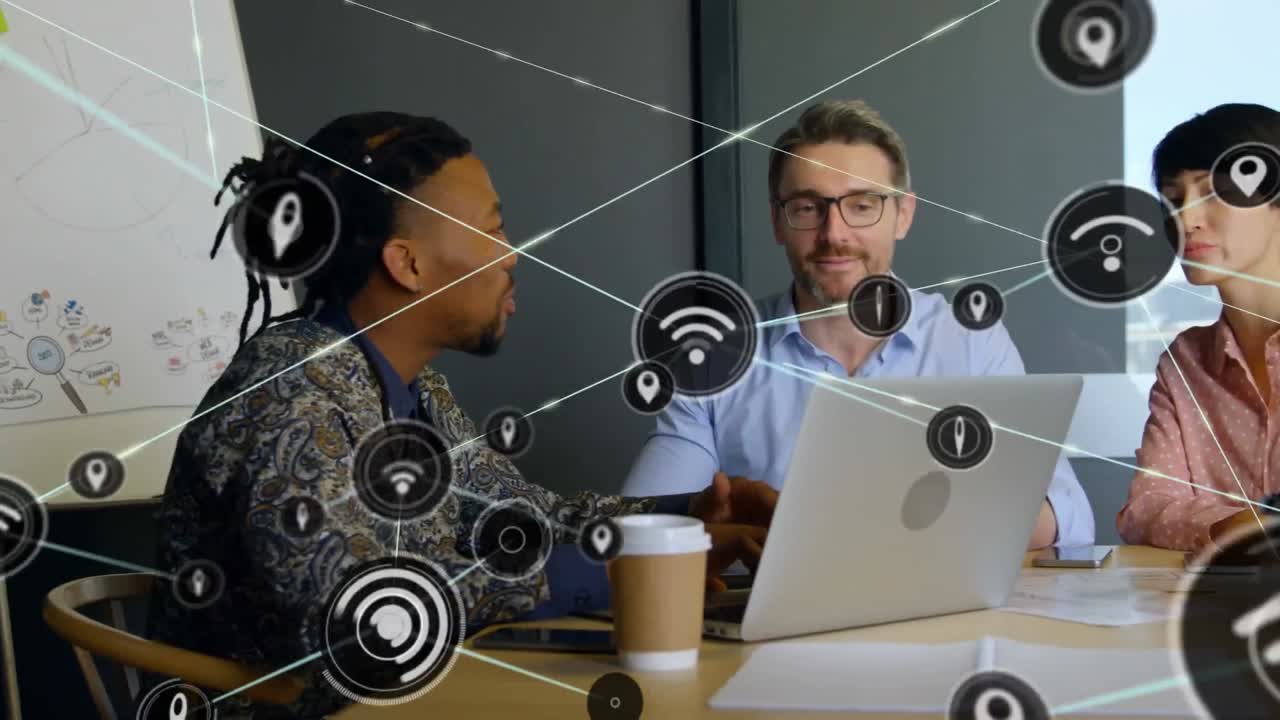 Animation of network of digital icons over diverse colleagues discussing together at office